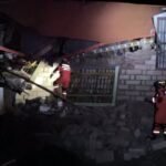 Rescuers use a torch while searching through building ruins in Nagqu city after the 7.0-magnitude quake in the northern Tibet region of China on Thursday night