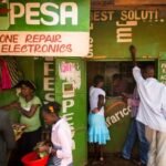 People use an M-Pesa mobile money service at a Nairobi phone repair shop
