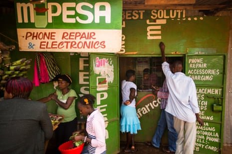 People use an M-Pesa mobile money service at a Nairobi phone repair shop