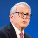 Man in front of blue background