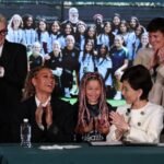 Trinity Rodman claps at her contract signing.