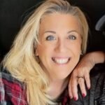 Becky Drury, a teacher wounded in a shooting, smiles resting her chin on her hand