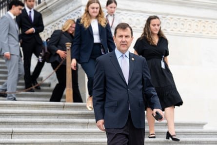 A man walks down steps as others follow behind